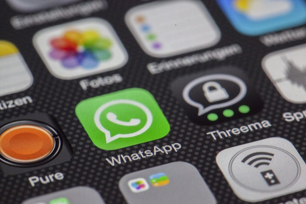 Mastering the First Impression: Your intriguing post title goes here Detailed macro of smartphone screen showcasing popular app icons like WhatsApp.
